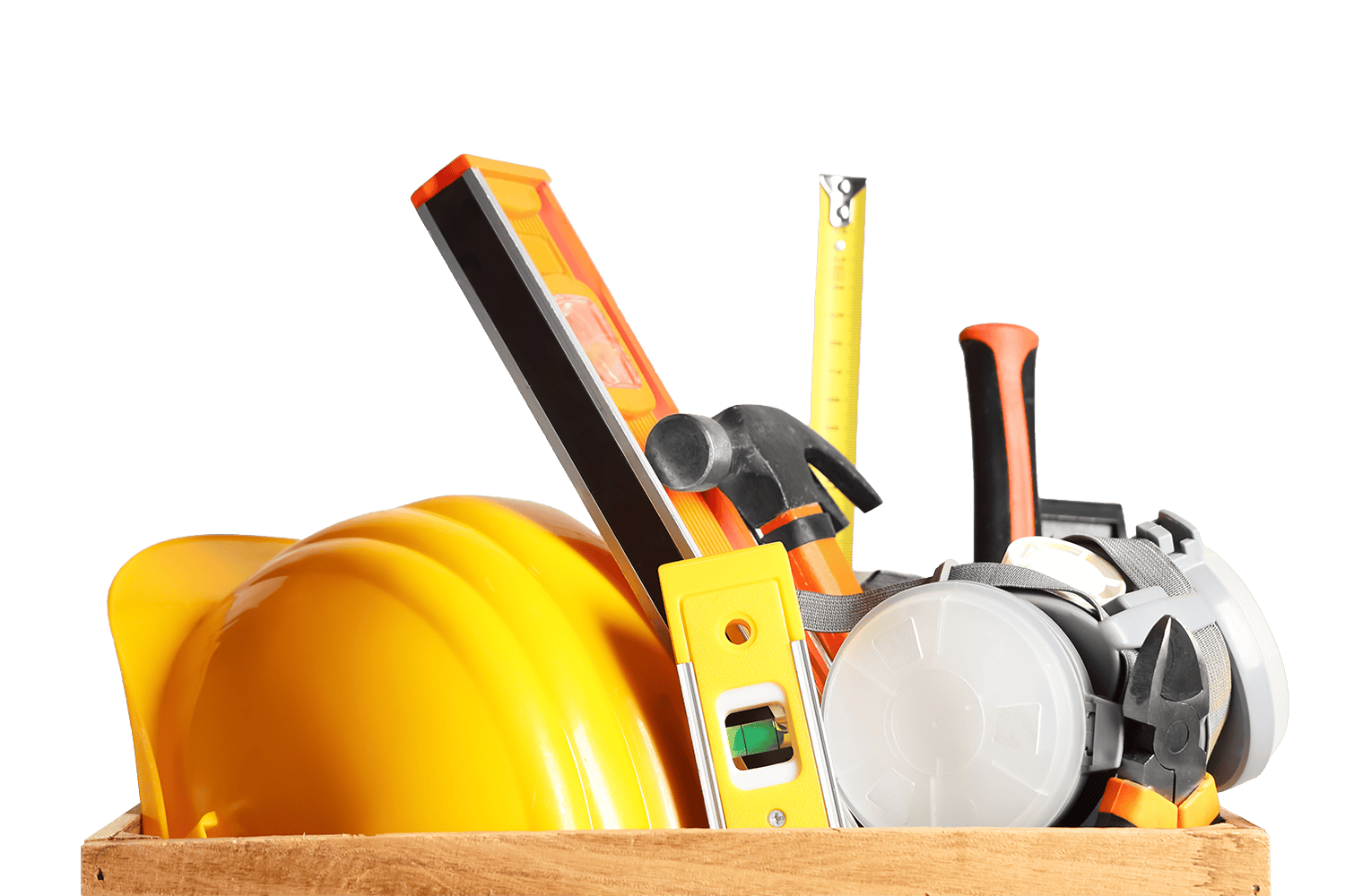 A yellow hard hat, level, hammer, tape measure, and safety goggles are arranged together in a wooden box against a white background.